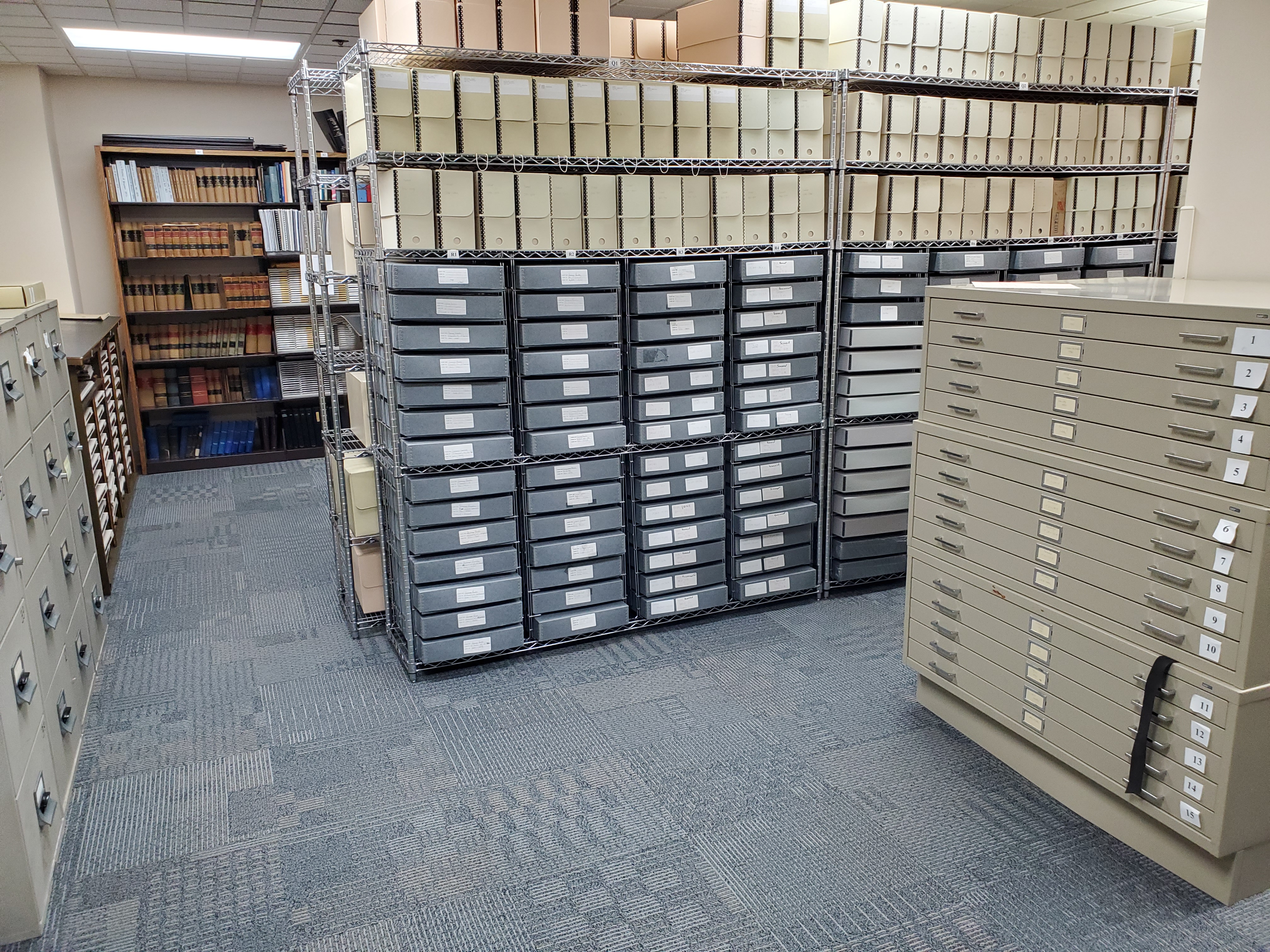 Inside the BCPL archive room showing full shelves, map drawers, and filing cabinets