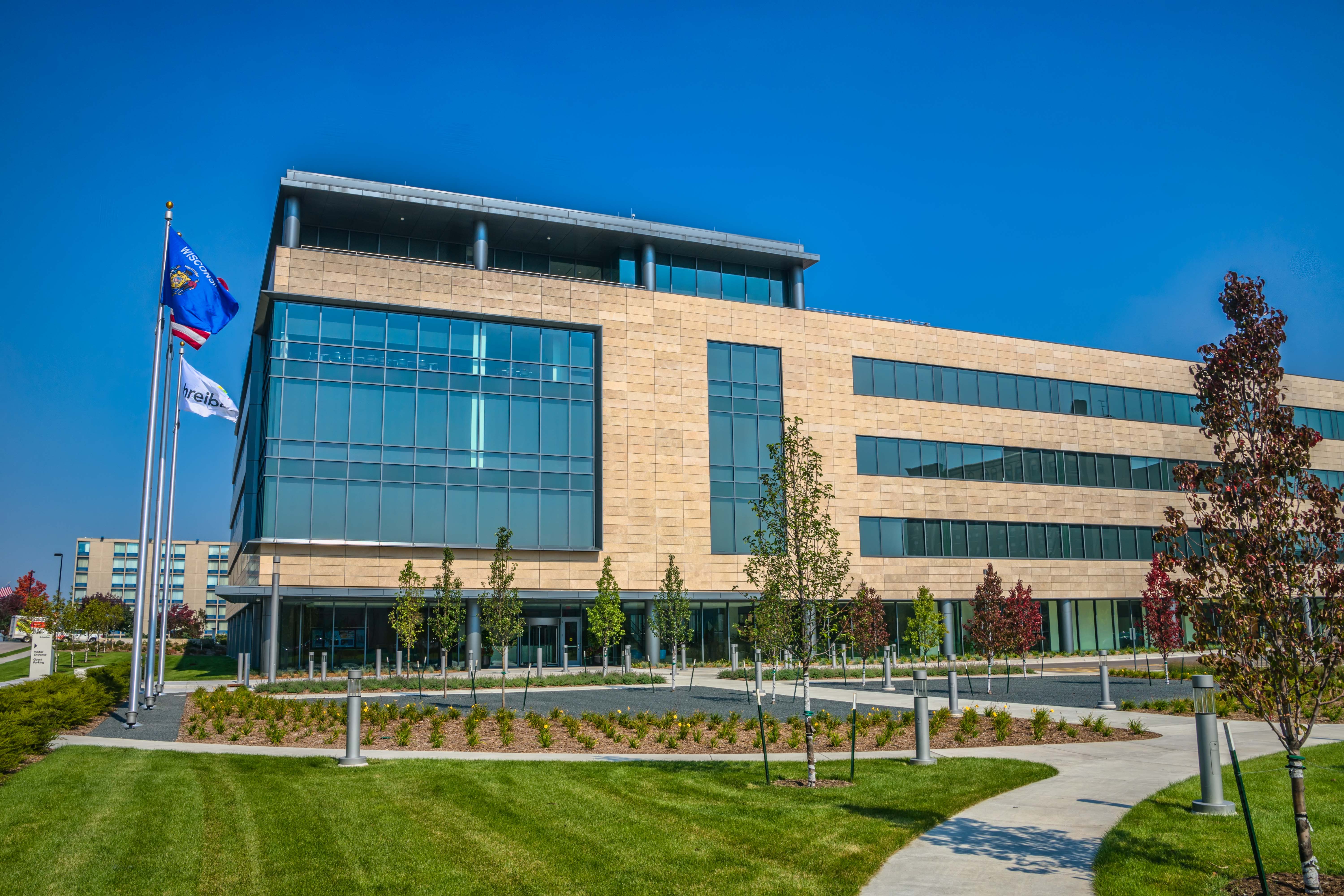 Large glass and tan brick 3 story Schreiber Foods building in the city of Green Bay