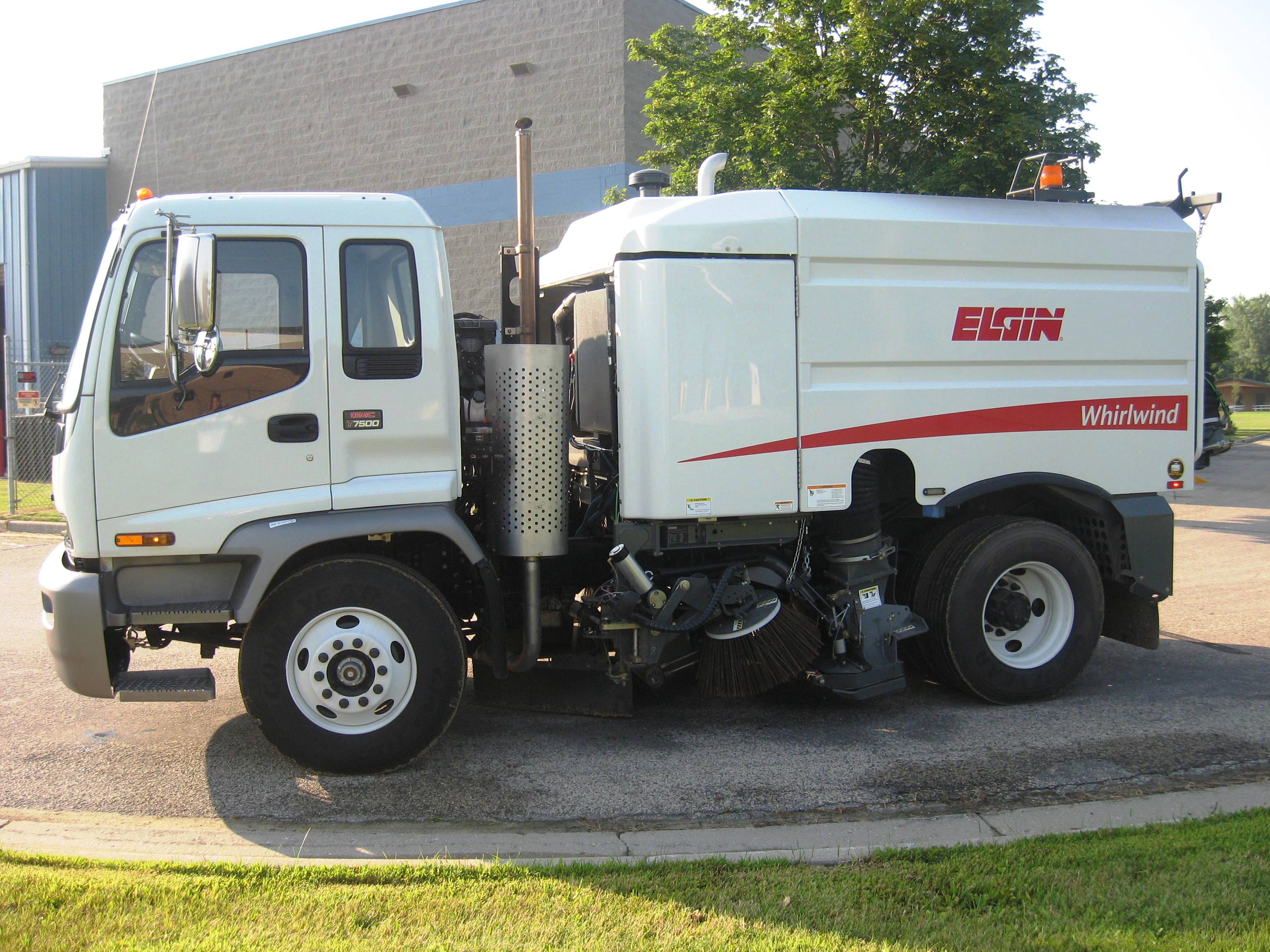 Driver's side image of a white Elgin whirlwind street sweeper in the City of Jefferesonstreet 