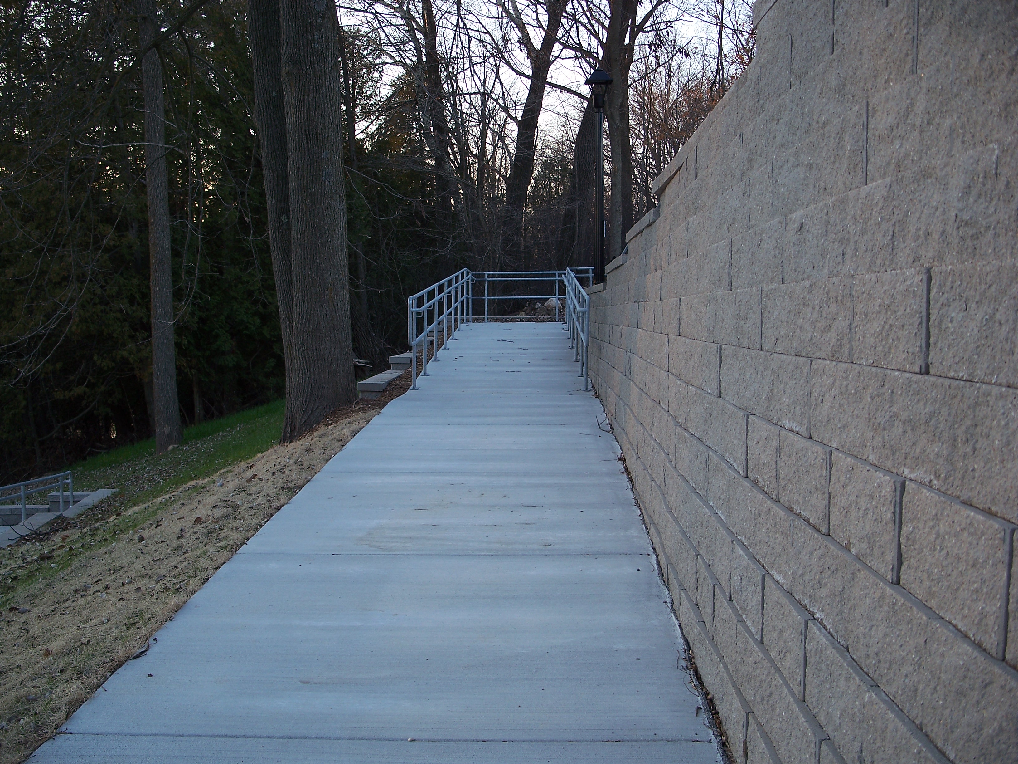 Village of Mishicot handicap ramp closeup with 9 block tall retaining wall on the right.